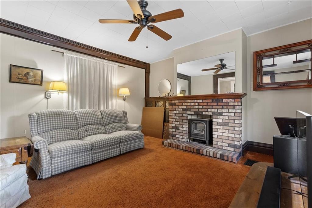 115 Meade Avenue Pittsburgh, PA 15202 - Photo 8 of 27 a living room with furniture and a fireplace