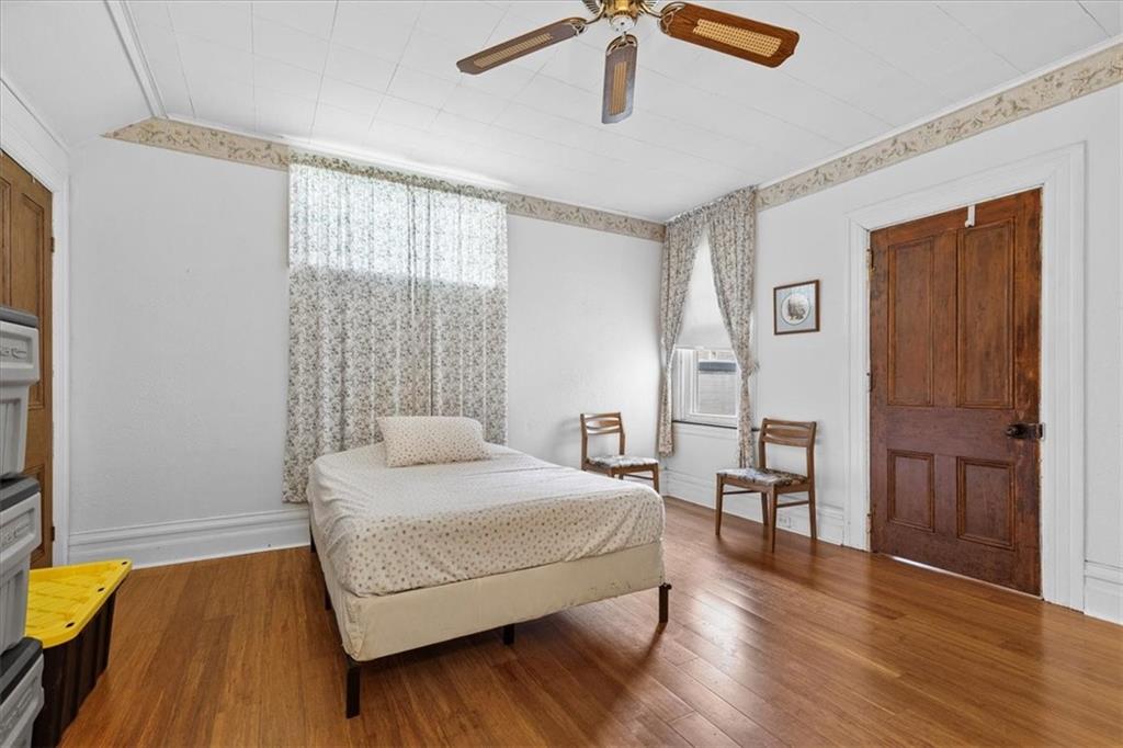 115 Meade Avenue Pittsburgh, PA 15202 - Photo 10 of 27 a bedroom with a bed and wooden floor