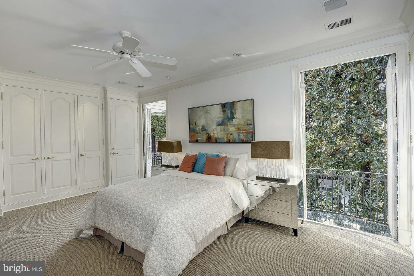 2130 Bancroft Place Northwest Washington, DC 20008 - Photo 14 of 20 a bedroom with a large bed and a chandelier fan