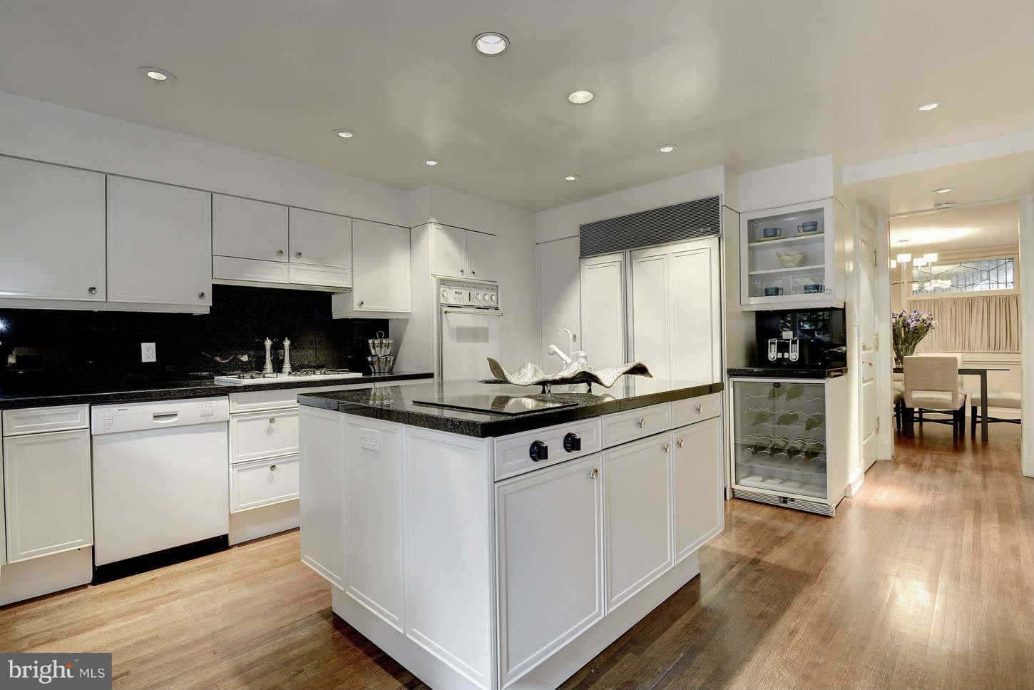 2130 Bancroft Place Northwest Washington, DC 20008 - Photo 7 of 20 a kitchen with stainless steel appliances granite countertop a stove top oven a sink and white cabinets
