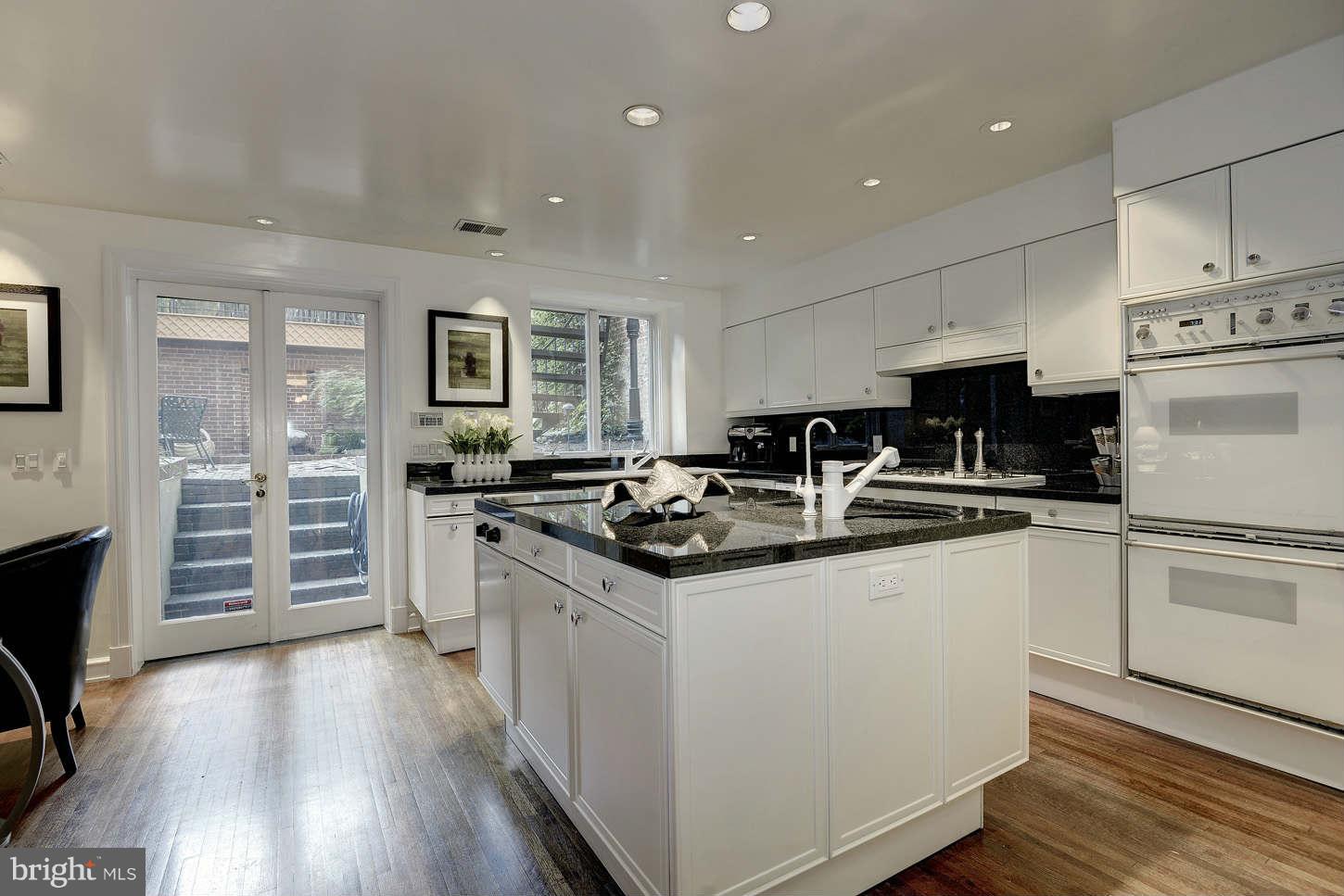 2130 Bancroft Place Northwest Washington, DC 20008 - Photo 8 of 20 a kitchen with stainless steel appliances granite countertop a sink stove and refrigerator