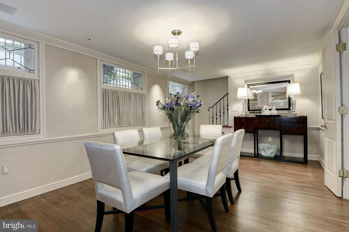 2130 Bancroft Place Northwest Washington, DC 20008 - Photo 9 of 20 a dining room with wooden floor a chandelier a wooden table and chairs