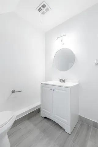 a bathroom with a sink a toilet and vanity