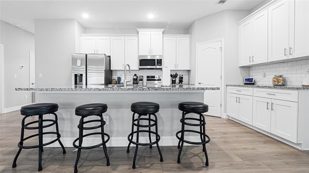8007 Southwest 135th Loop Ocala, FL 34473 - Photo 12 of 47 a kitchen with stainless steel appliances a sink and cabinets