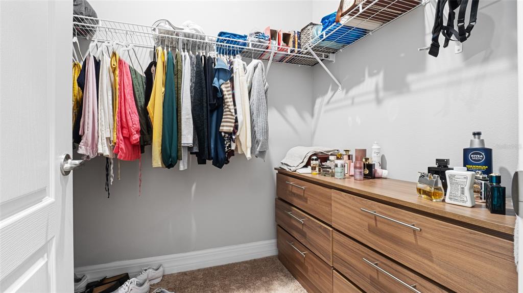 8007 Southwest 135th Loop Ocala, FL 34473 - Photo 20 of 47 a view of walk in closet with clothes and shoes