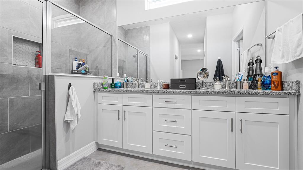 8007 Southwest 135th Loop Ocala, FL 34473 - Photo 21 of 47 a bathroom with cabinets and white appliances