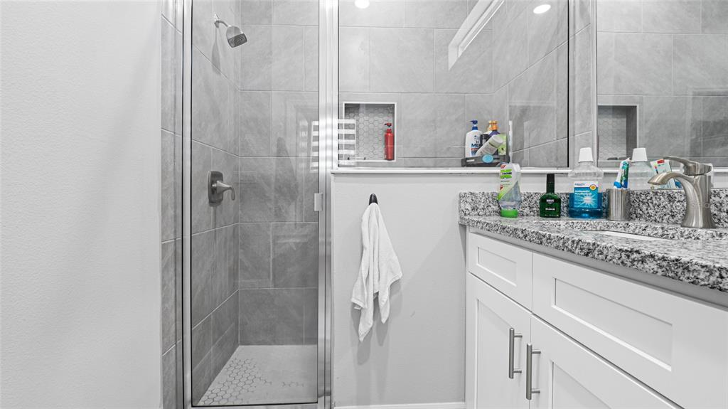 8007 Southwest 135th Loop Ocala, FL 34473 - Photo 23 of 47 a bathroom with a granite countertop shower sink and mirror