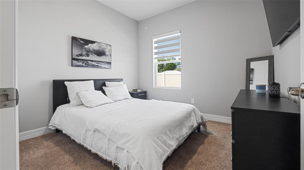 8007 Southwest 135th Loop Ocala, FL 34473 - Photo 26 of 47 a bedroom with bed and a window