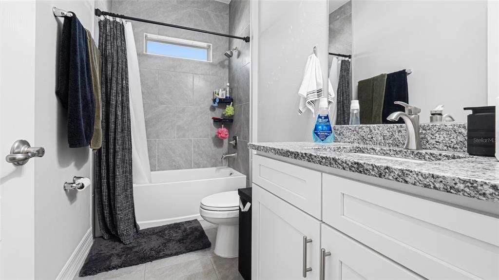 8007 Southwest 135th Loop Ocala, FL 34473 - Photo 28 of 47 a bathroom with a granite countertop sink toilet and shower