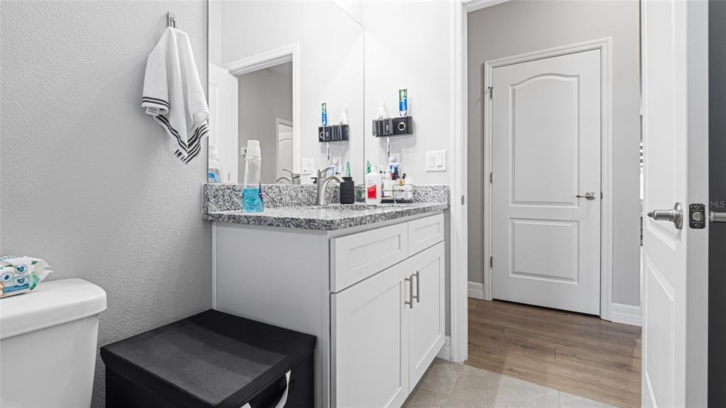 8007 Southwest 135th Loop Ocala, FL 34473 - Photo 29 of 47 a bathroom with a sink a toilet and mirror