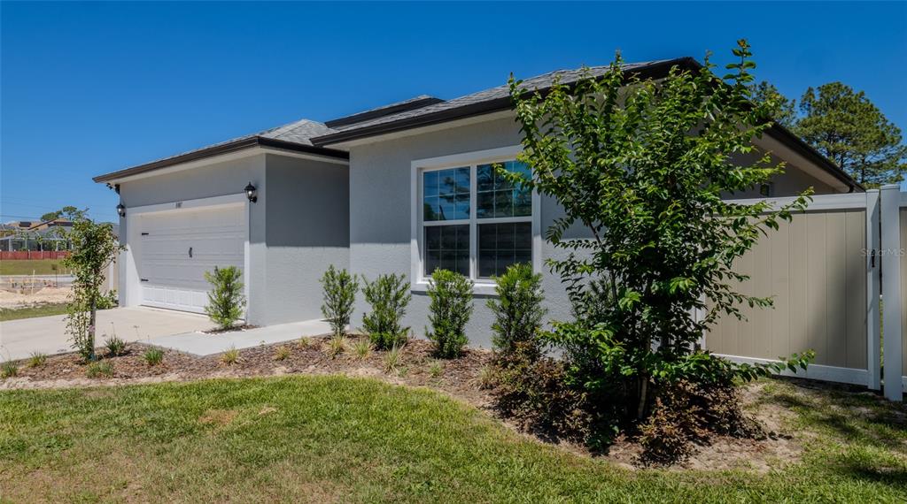 8007 Southwest 135th Loop Ocala, FL 34473 - Photo 3 of 47 front view of a house with a yard