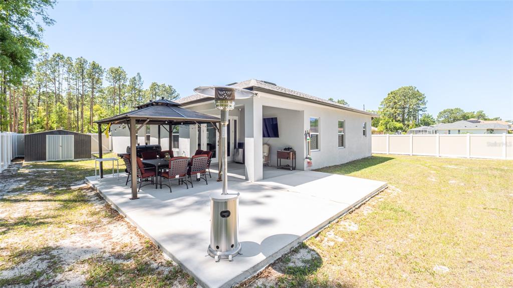 8007 Southwest 135th Loop Ocala, FL 34473 - Photo 40 of 47 a swimming pool with outdoor seating and yard