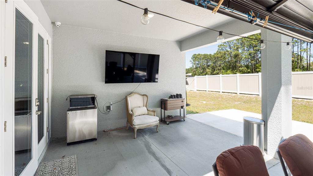 8007 Southwest 135th Loop Ocala, FL 34473 - Photo 46 of 47 a living room with furniture and a flat screen tv