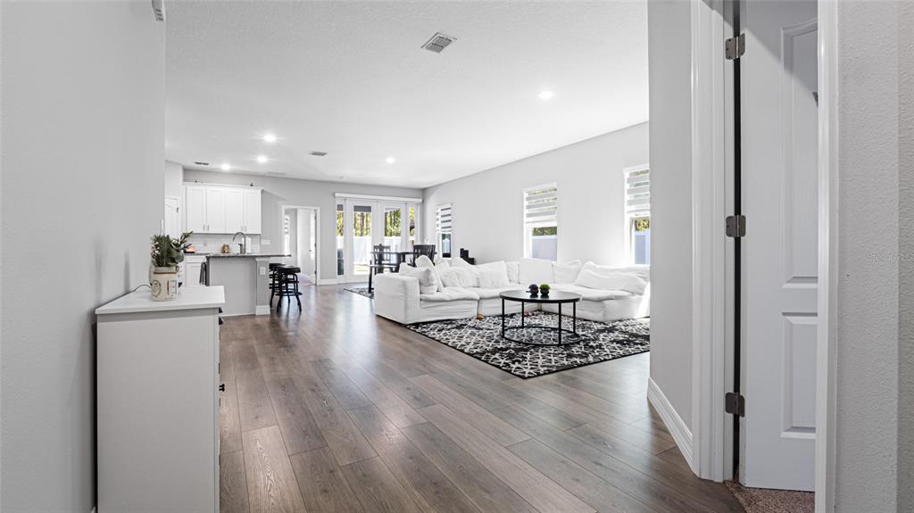 8007 Southwest 135th Loop Ocala, FL 34473 - Photo 8 of 47 a living room with furniture and wooden floor