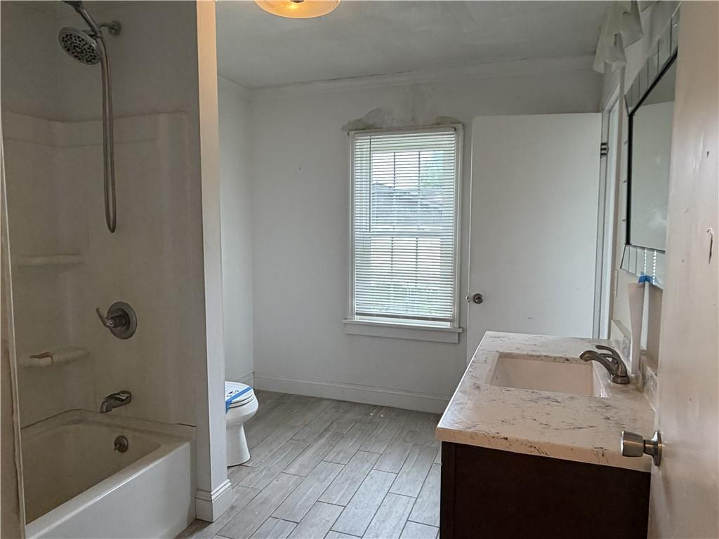 1146 Franklin Road Jackson Center, PA 16133 - Photo 11 of 19 a bathroom with a granite countertop sink a toilet and bathtub