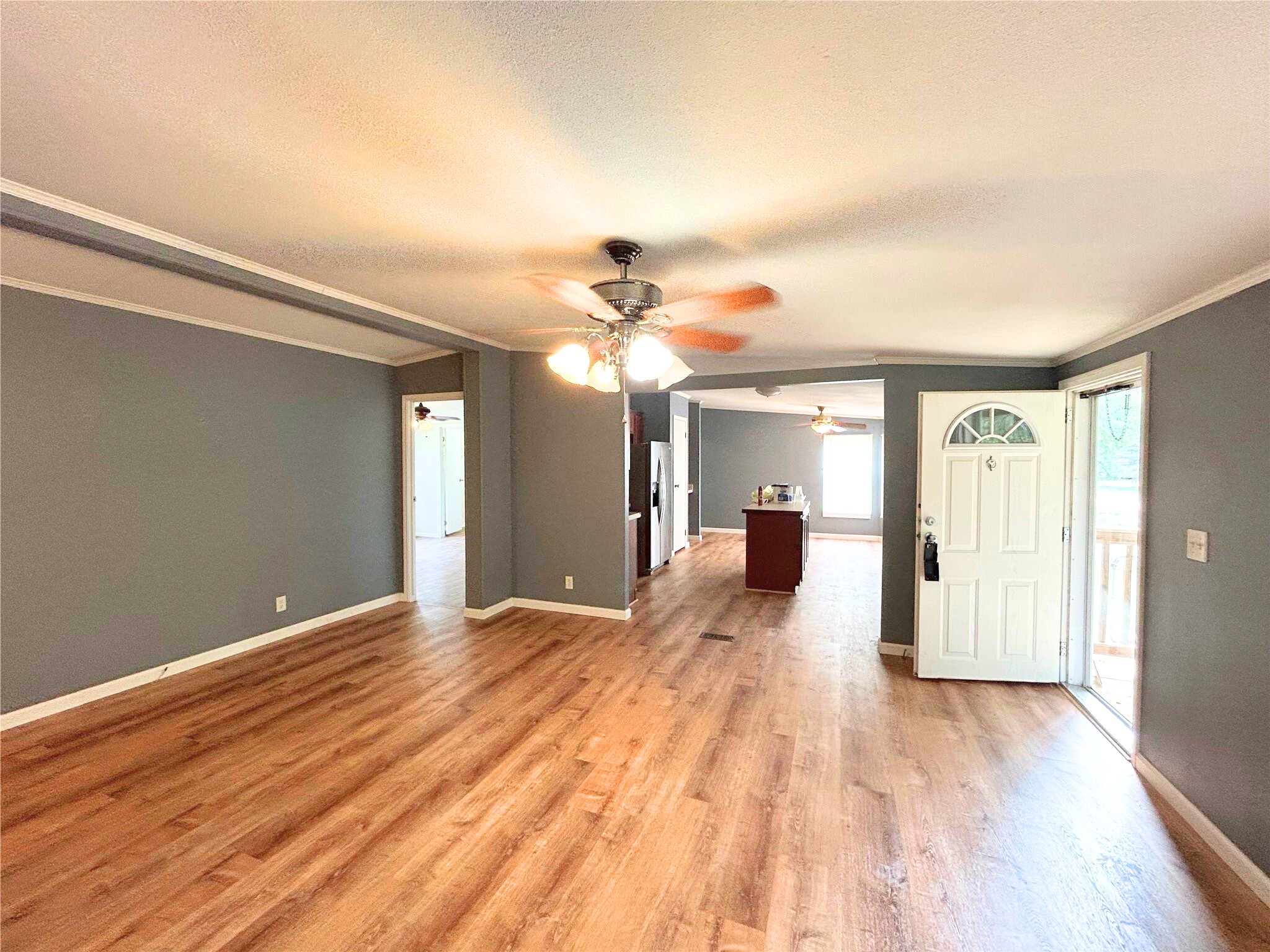772 County Road 2191 Cleveland, TX 77327 - Photo 12 of 24 a view of a room with wooden floor ceiling fan and windows