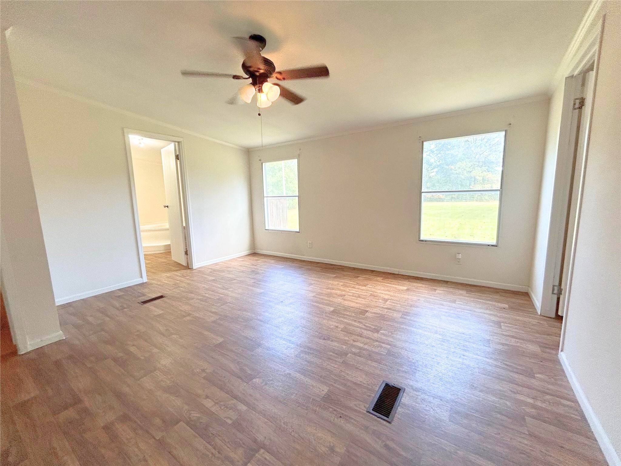 772 County Road 2191 Cleveland, TX 77327 - Photo 15 of 24 a view of an empty room with a window and wooden floor