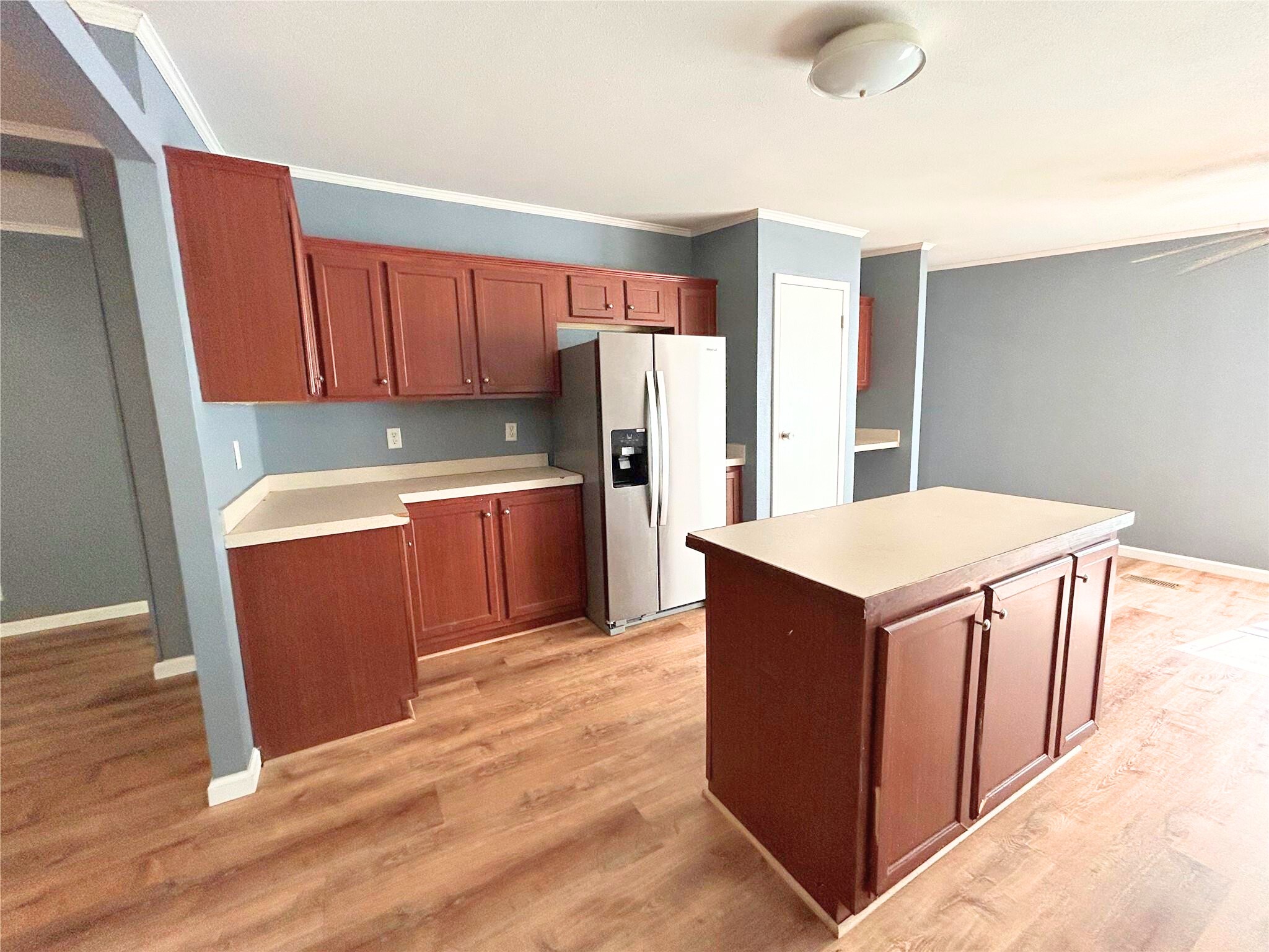 772 County Road 2191 Cleveland, TX 77327 - Photo 7 of 24 a kitchen with stainless steel appliances a refrigerator and wooden cabinets