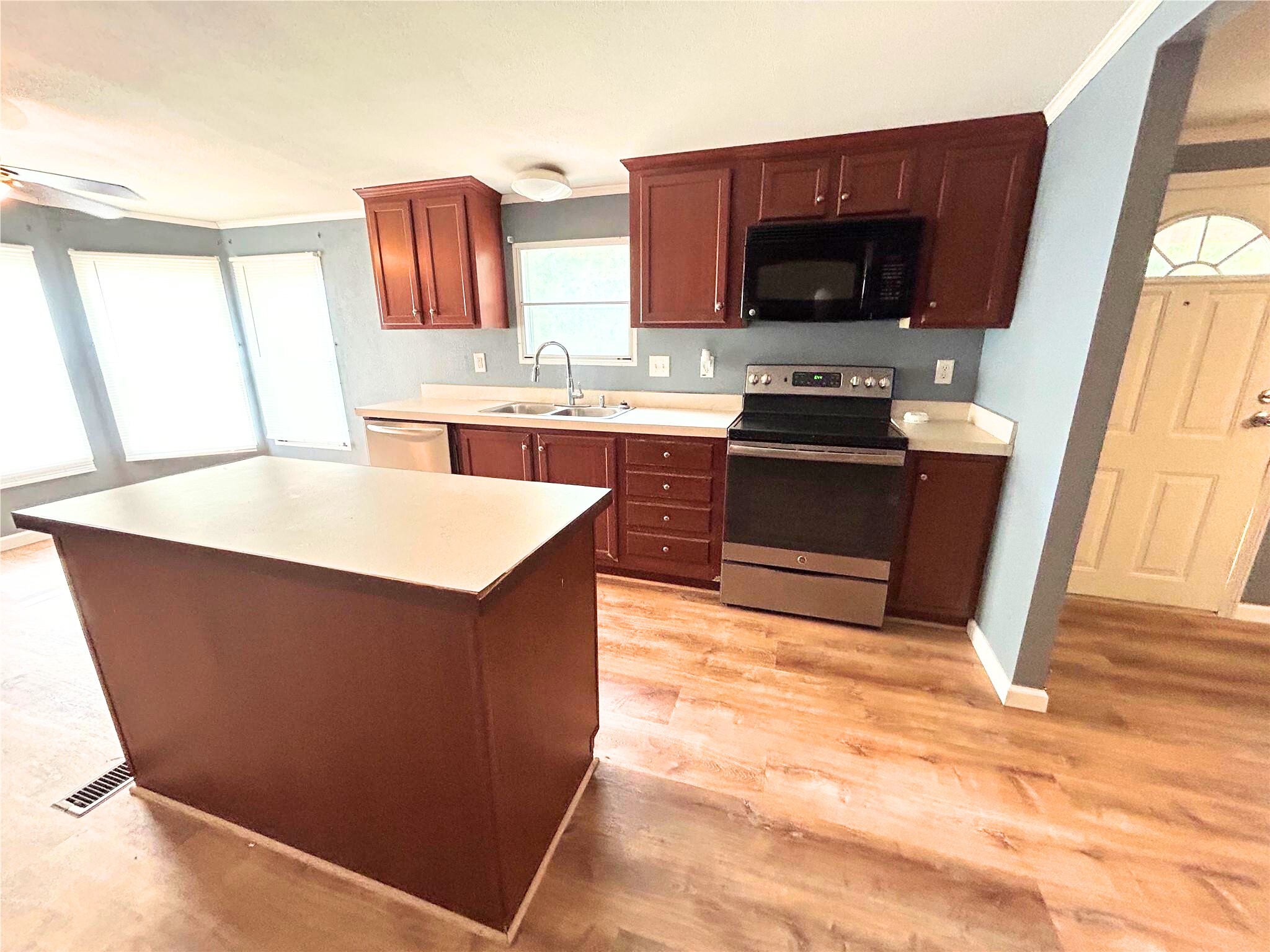 772 County Road 2191 Cleveland, TX 77327 - Photo 9 of 24 a kitchen with stainless steel appliances granite countertop a stove a sink and a microwave