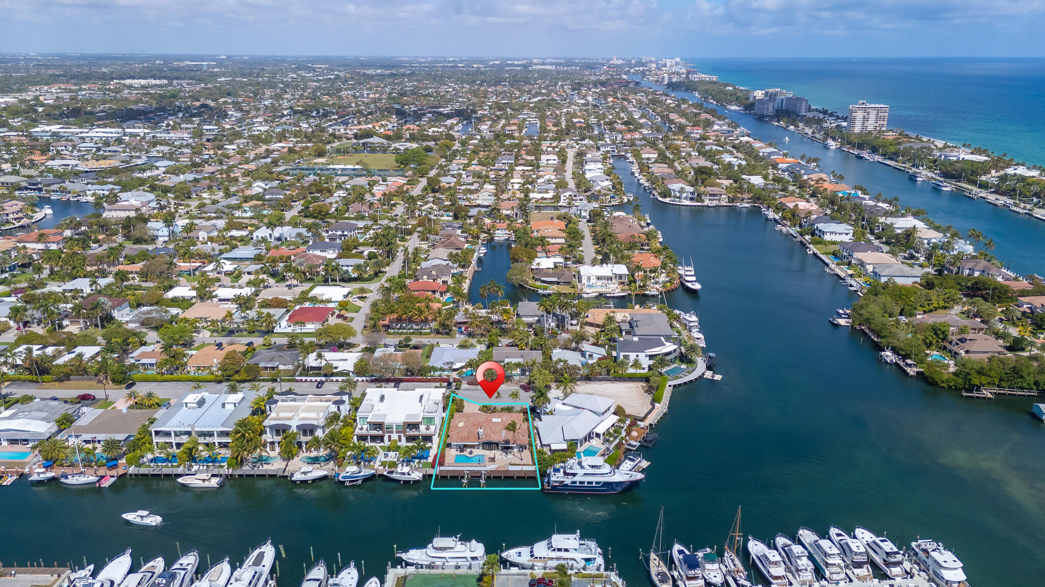 an aerial view of a city with lots of residential buildings ocean and mountain view in back