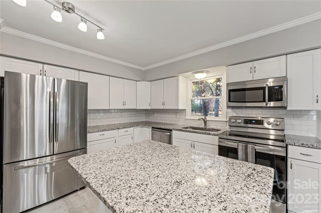 328 Sundown Road Mooresville, NC 28117 - Photo 17 of 32 a kitchen with stainless steel appliances granite countertop a refrigerator sink and stove