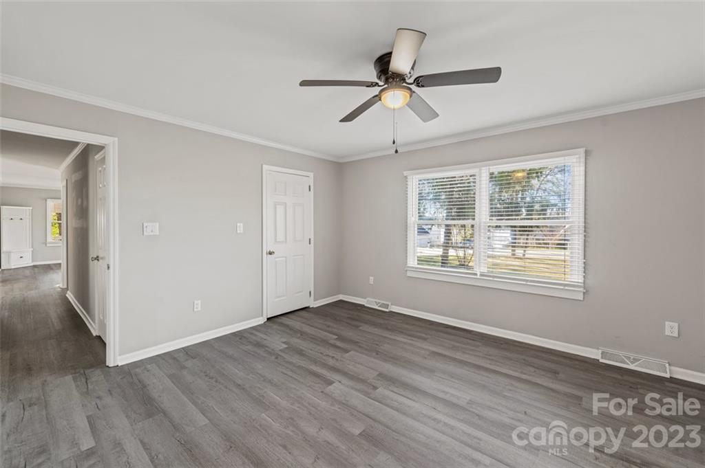 328 Sundown Road Mooresville, NC 28117 - Photo 21 of 32 a view of an empty room with wooden floor and a window