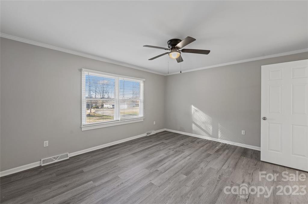 328 Sundown Road Mooresville, NC 28117 - Photo 23 of 32 a view of empty room with wooden floor and fan