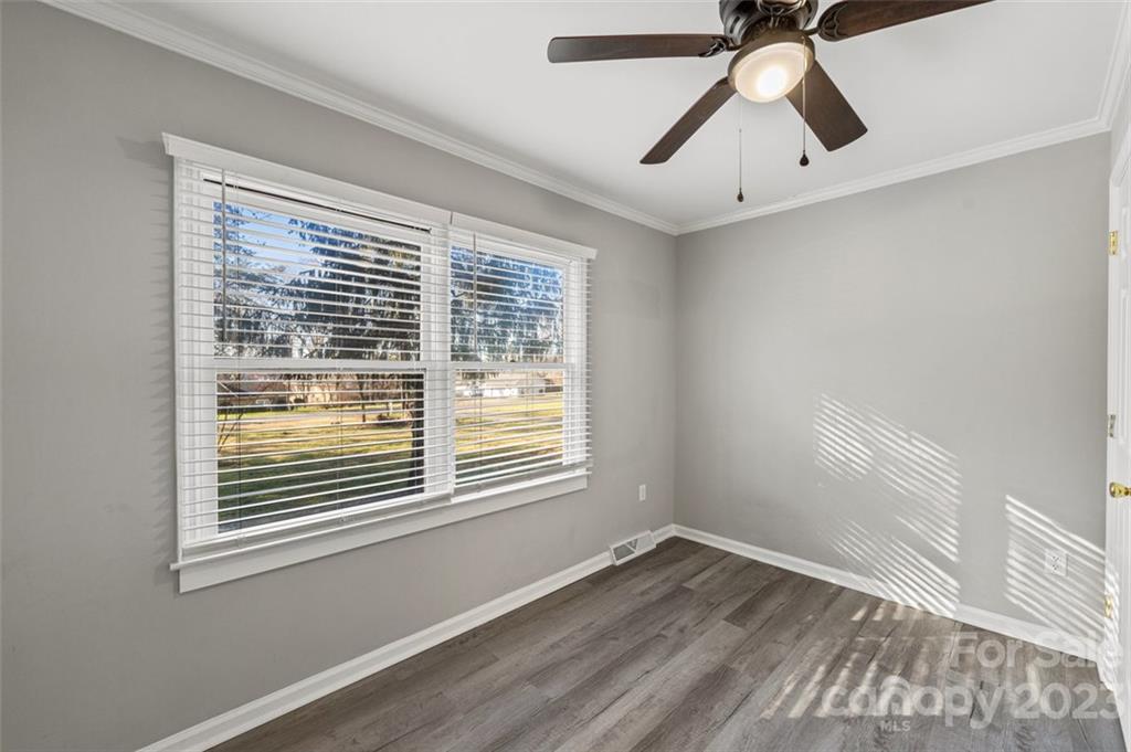 328 Sundown Road Mooresville, NC 28117 - Photo 25 of 32 a view of empty room with wooden floor and fan