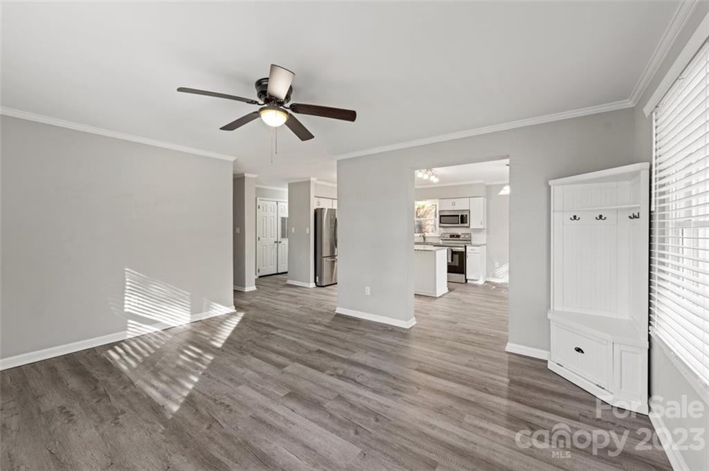 328 Sundown Road Mooresville, NC 28117 - Photo 26 of 32 a view of a living room with wooden floor and a ceiling fan