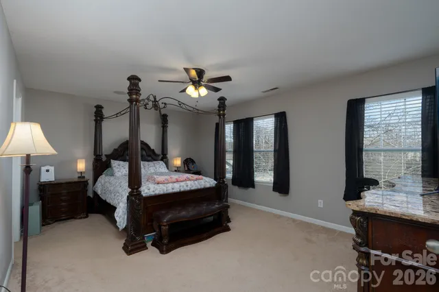 a bedroom with bed and window