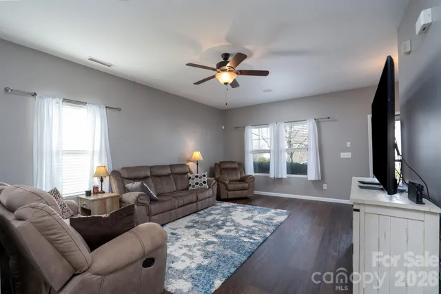 a living room with furniture window and wooden floor