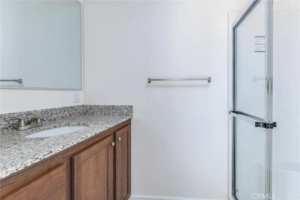 1255 Orcutt Road, Unit B14 San Luis Obispo, CA 93401 - Photo 11 of 11 a bathroom with a granite countertop sink and a mirror