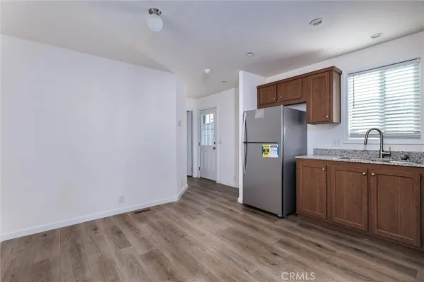 a kitchen with stainless steel appliances granite countertop a refrigerator and a sink