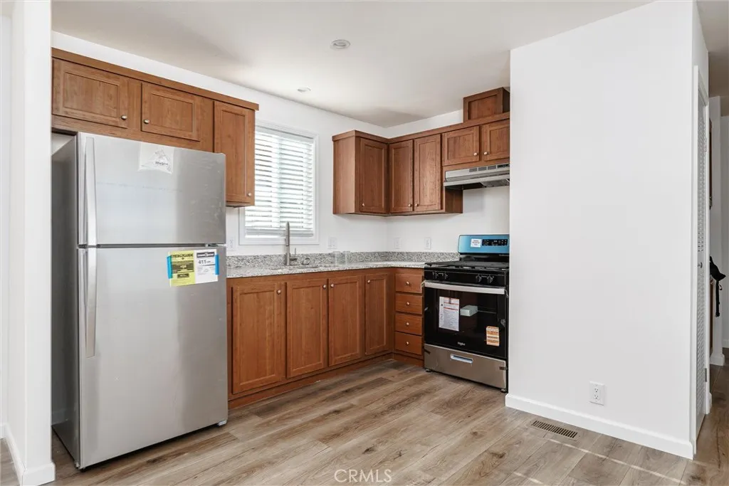 1255 Orcutt Road, Unit B14 San Luis Obispo, CA 93401 - Photo 5 of 11 a kitchen with stainless steel appliances granite countertop a refrigerator sink and stove