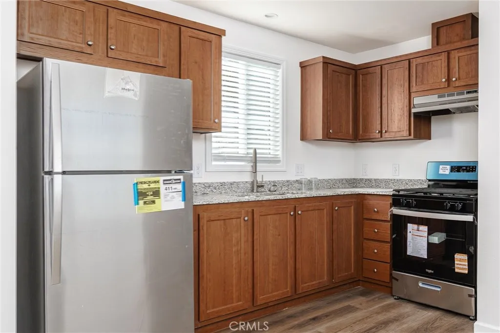 1255 Orcutt Road, Unit B14 San Luis Obispo, CA 93401 - Photo 6 of 11 a kitchen with stainless steel appliances granite countertop a refrigerator sink and cabinets
