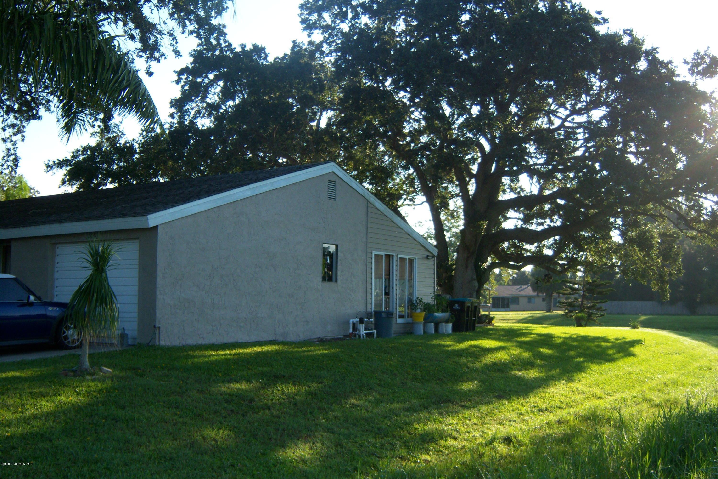 1556 Creel Road Northeast Palm Bay, FL 32905 - Photo 3 of 23 Side yard view