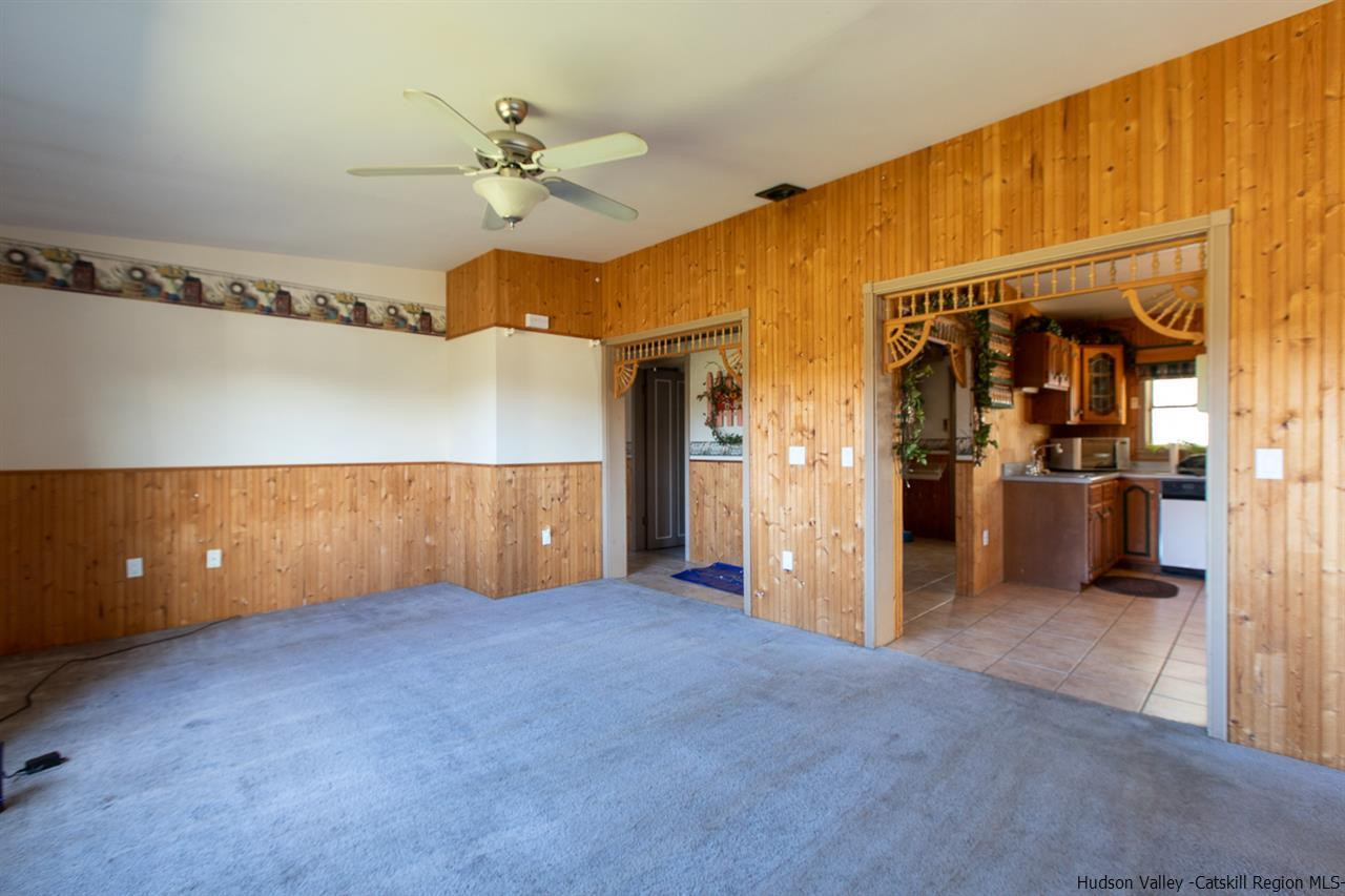 225 Pine Bush Road Stone Ridge, NY 12484 - Photo 6 of 29 a view of a room with a ceiling fan and refrigerator