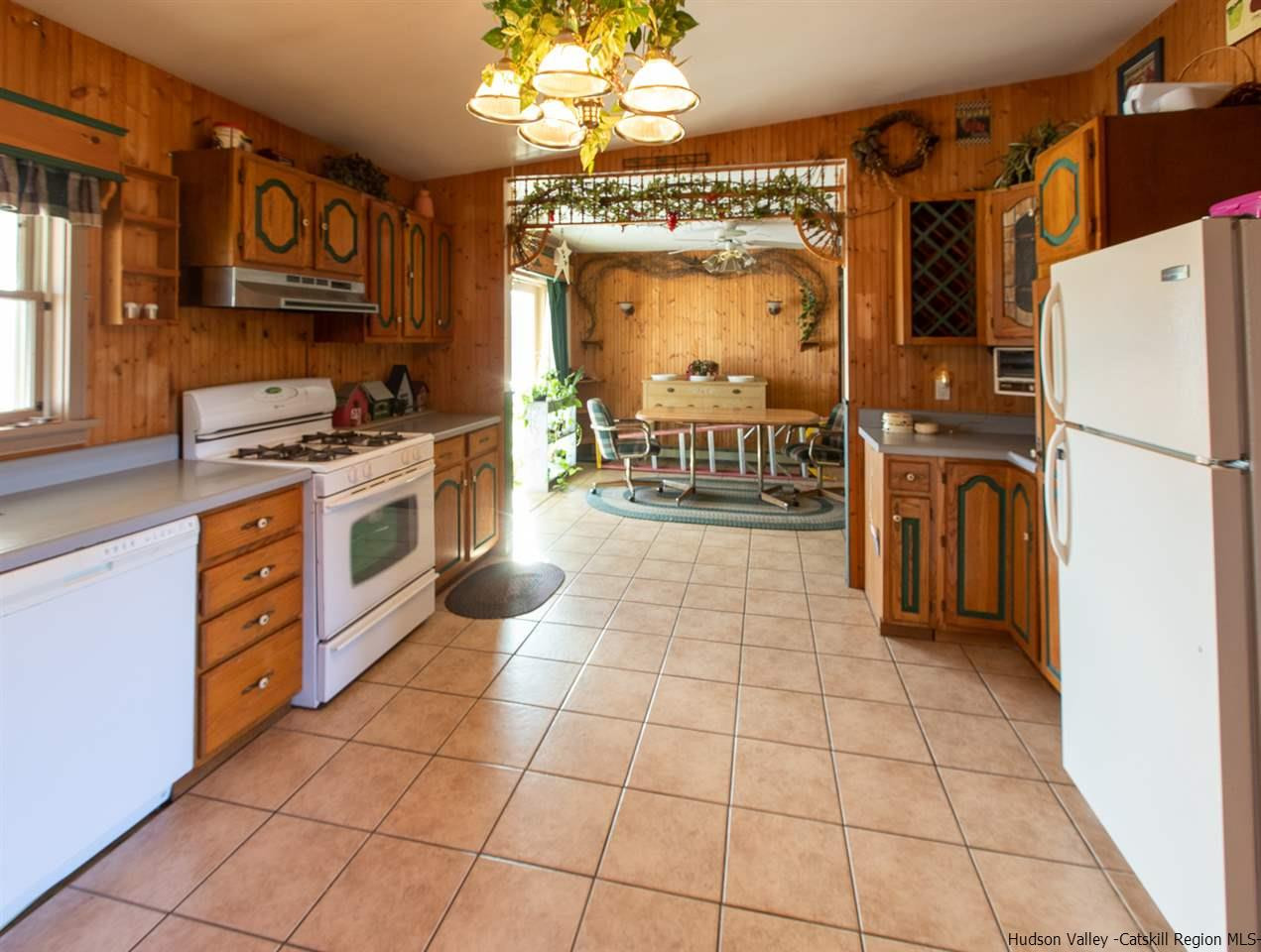 225 Pine Bush Road Stone Ridge, NY 12484 - Photo 7 of 29 a kitchen with a stove a refrigerator and cabinets