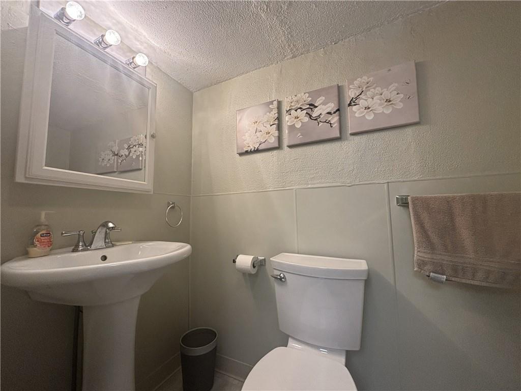 100 Spruce Street Rillton, PA 15678 - Photo 13 of 43 a bathroom with a toilet sink and mirror