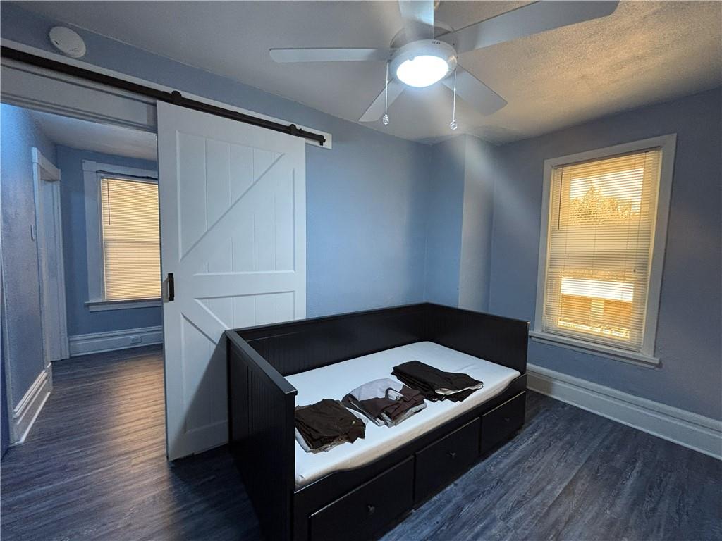 100 Spruce Street Rillton, PA 15678 - Photo 31 of 43 a bedroom with wooden floor a ceiling fan and a window