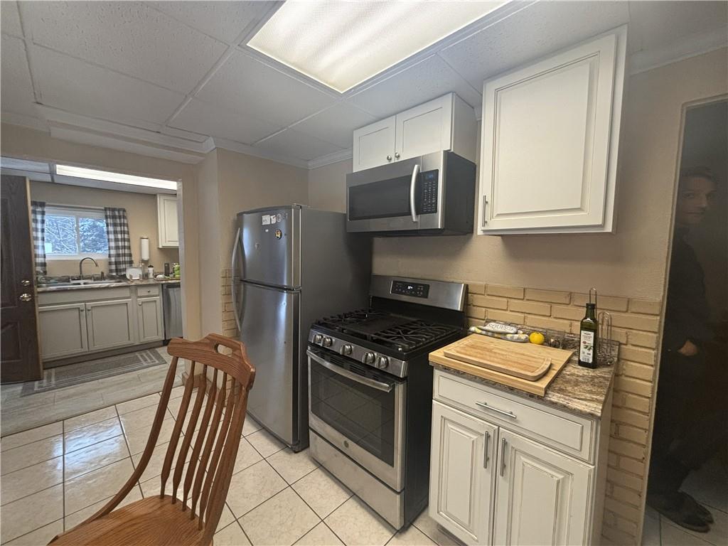 100 Spruce Street Rillton, PA 15678 - Photo 10 of 43 a kitchen with stainless steel appliances granite countertop a stove a sink and a microwave