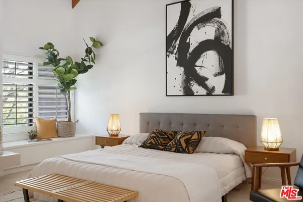 a bedroom with a bed and a chair