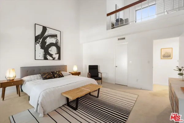 a bedroom with a bed and chair