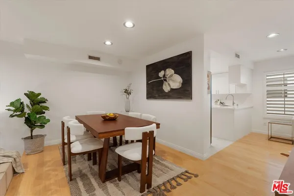 a view of a workspace with furniture and wooden floor