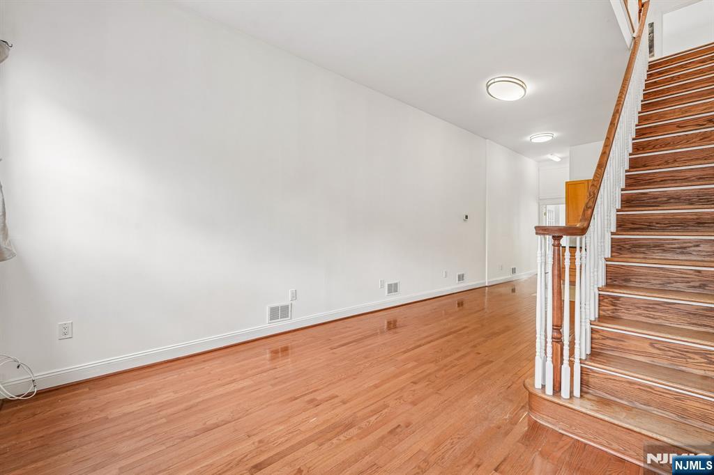 90 A Hackensack Plank Road Weehawken, NJ 07086 - Photo 6 of 40 wooden floor in an empty room with stairs