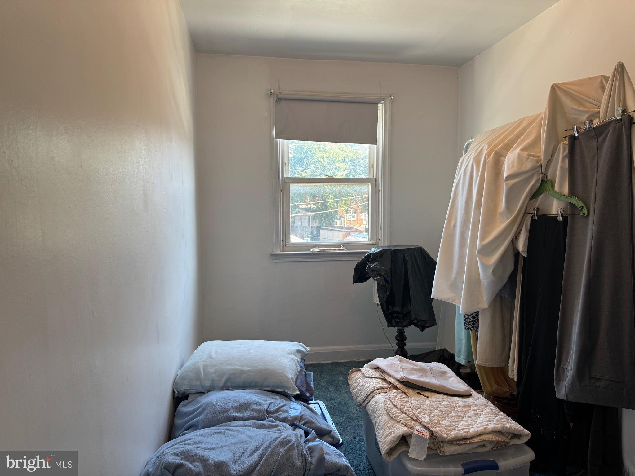 349 Grove Park Road Baltimore, MD 21225 - Photo 15 of 22 a bedroom with a bed closet and a window