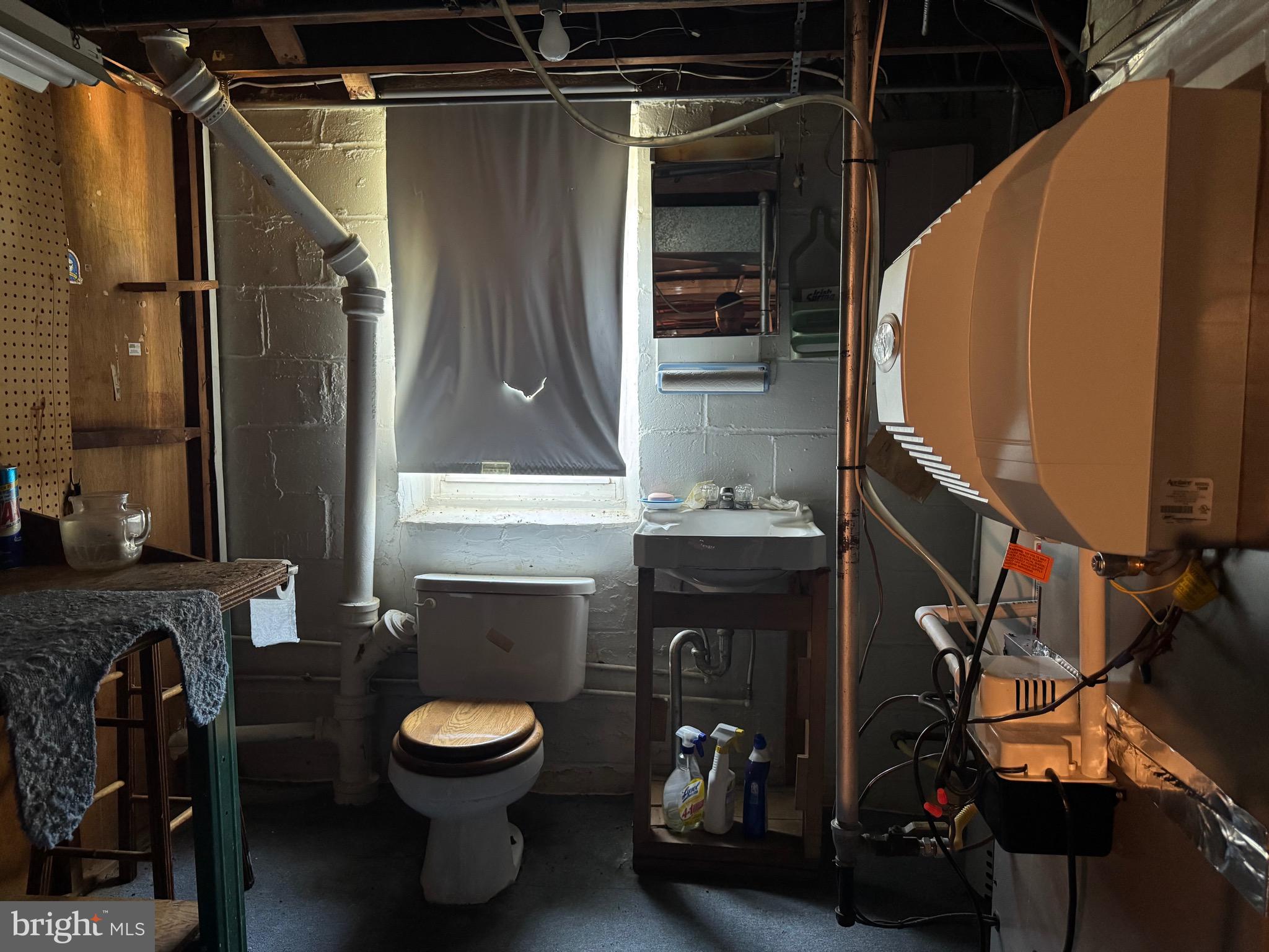 349 Grove Park Road Baltimore, MD 21225 - Photo 16 of 22 a bathroom with a toilet a sink and mirror