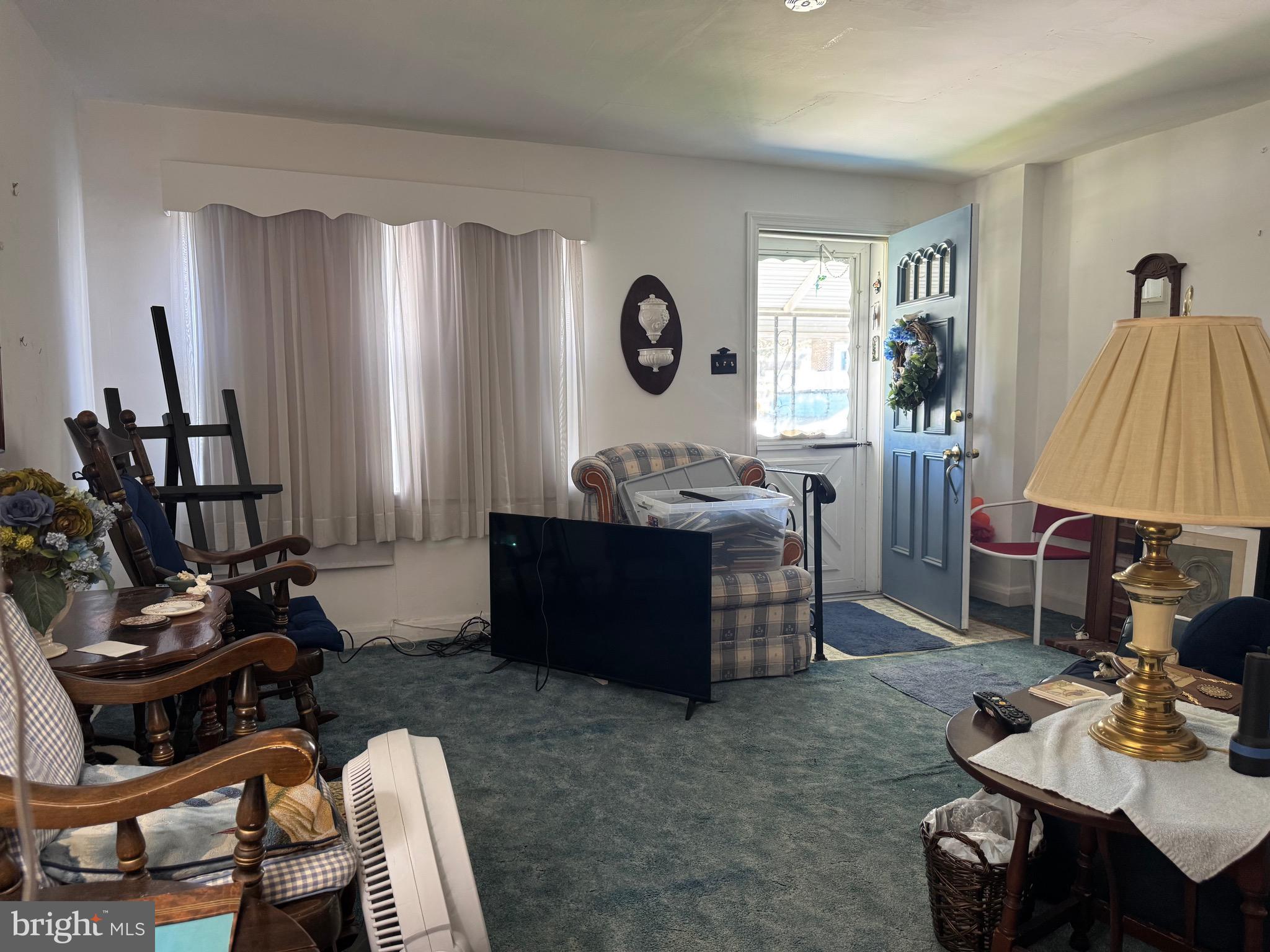 349 Grove Park Road Baltimore, MD 21225 - Photo 3 of 22 a living room with furniture a window and gym equipment