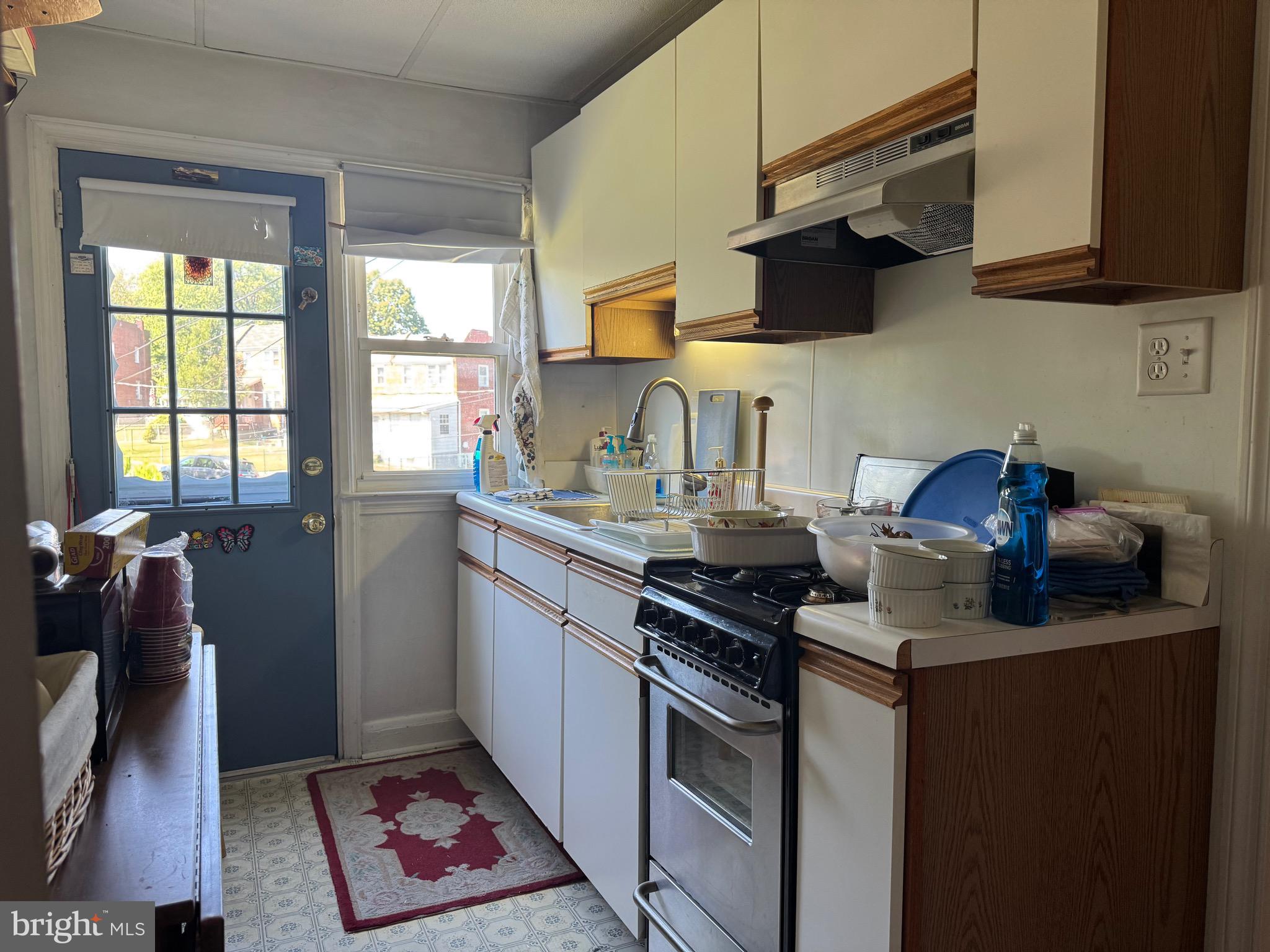 349 Grove Park Road Baltimore, MD 21225 - Photo 8 of 22 a kitchen with stainless steel appliances granite countertop a sink stove and cabinets