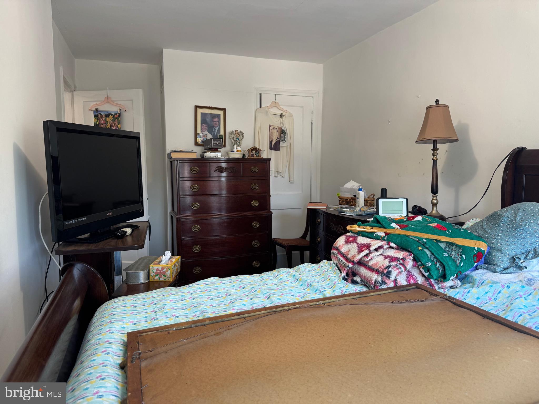 349 Grove Park Road Baltimore, MD 21225 - Photo 10 of 22 a bedroom with a bed and a flat tv screen on dresser
